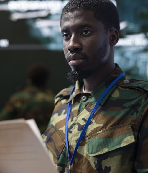 Army soldier reading a new defense mission case file in federal headquarters